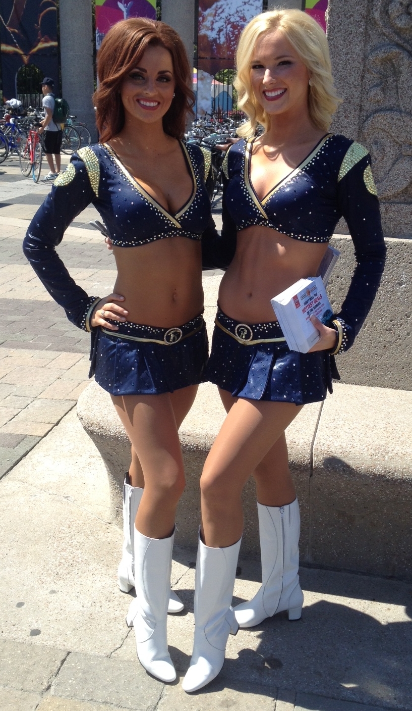 Two Cheerleaders wearing Tan Sheer Nylon Tights, White Boots and Blue Miniskirts